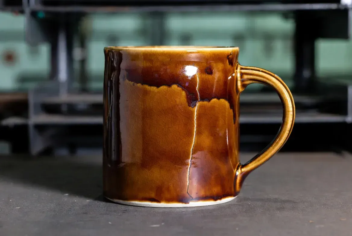 a ceramic mug with glaze crawling and hairline crack